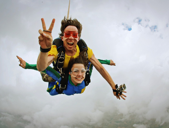 Skydiving tandem happiness on a cloudy day