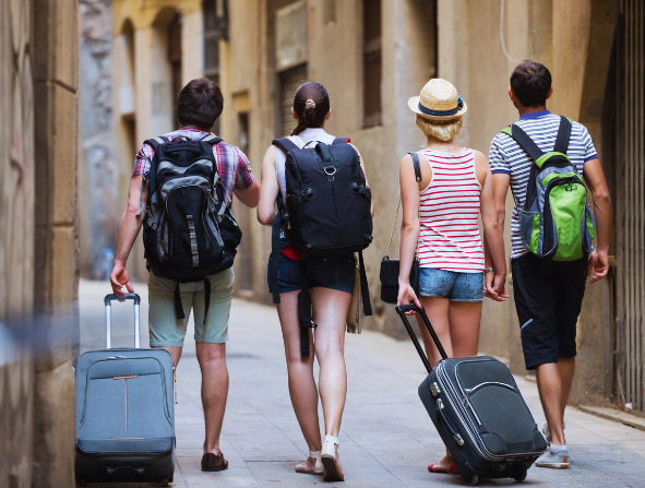 Travelers with travel bags walking