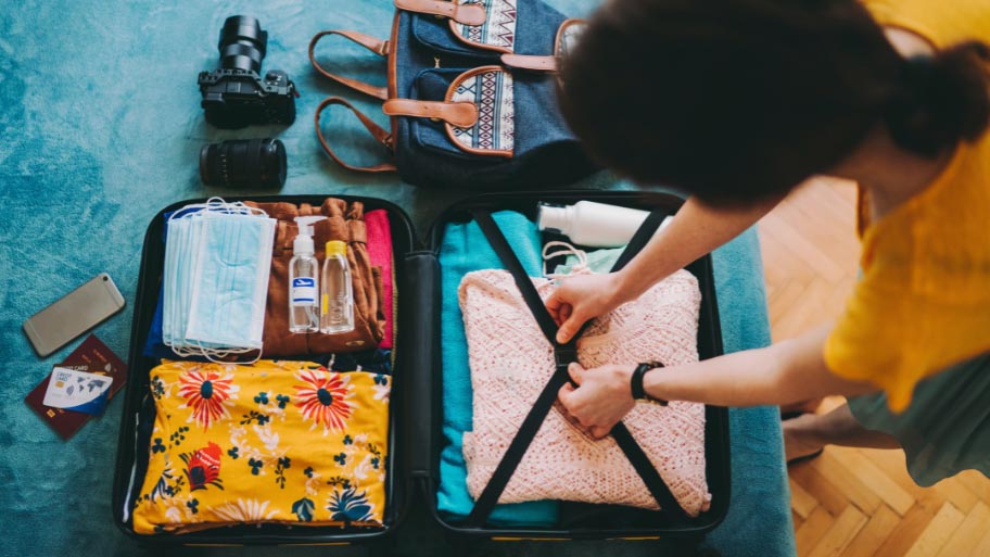 Woman packing suitcase for travel