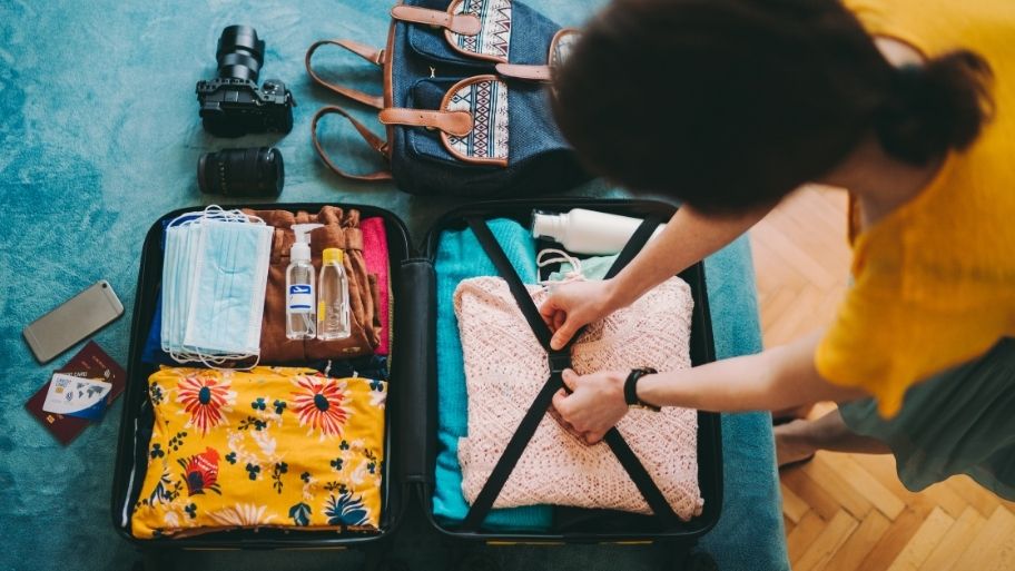 Woman packing suitcase for travel