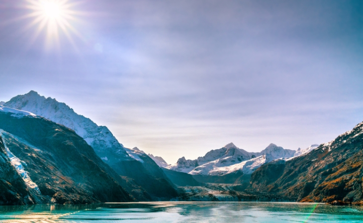 Alaska Cruise Glacier Bay Travel Landscape View from Ship at Johns Hopkins Glacier in Alaska, United States USA. Summer Sun Flare