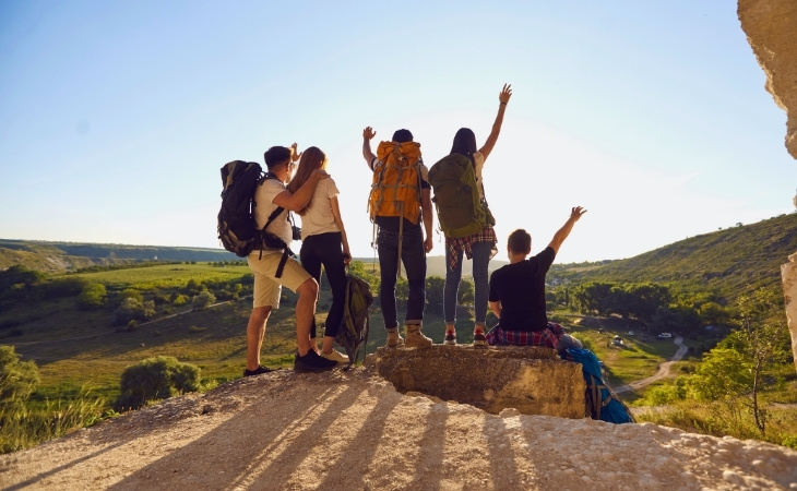 Business Group of Travelers Celebrating Victory on Hill