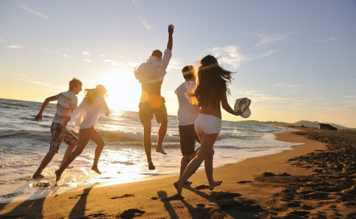 People Group Running on the Beach