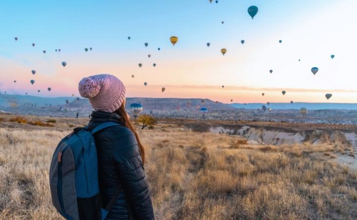 Woman Looking At Hot Air Balloons