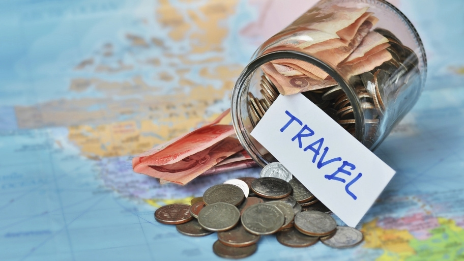 Travel budget - vacation money savings in a glass jar